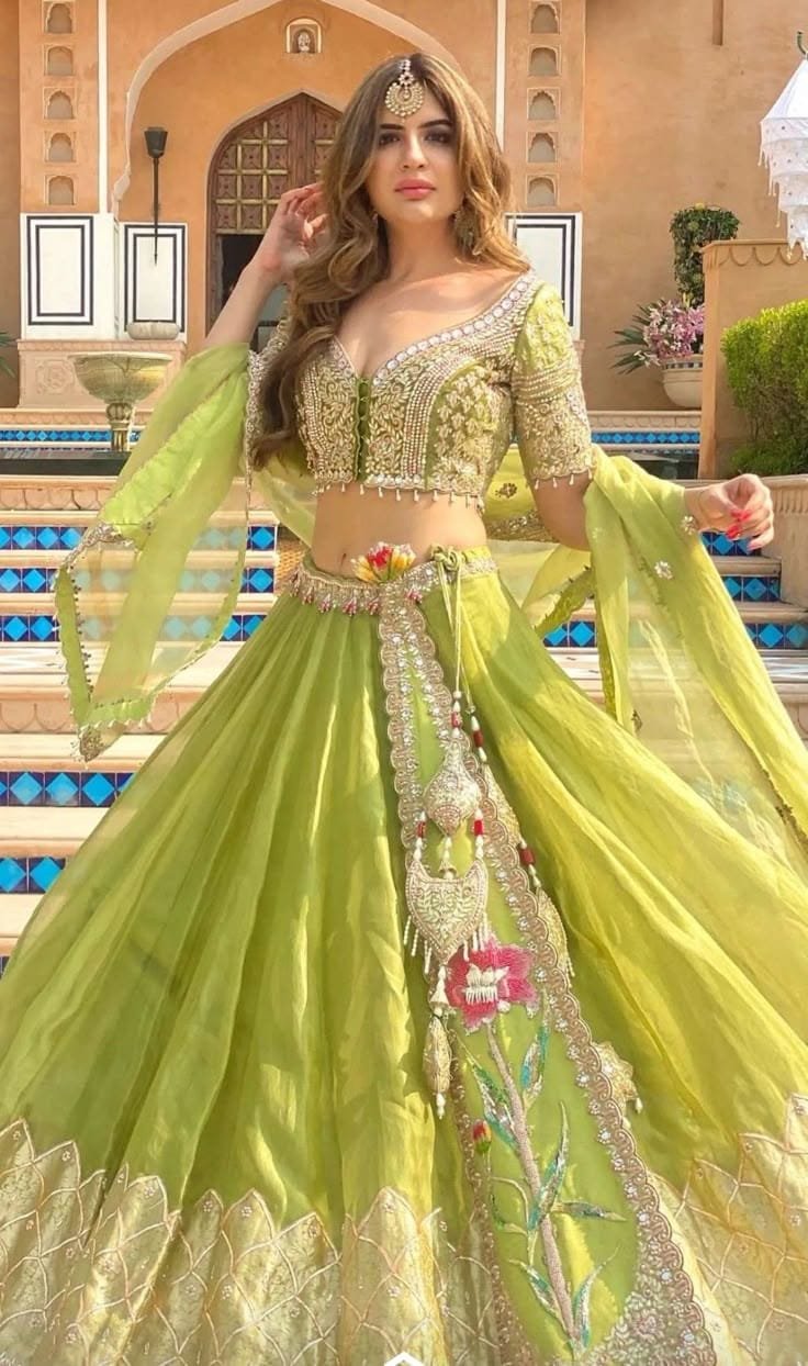Model in a lime organza lehenga with an embroidered blouse